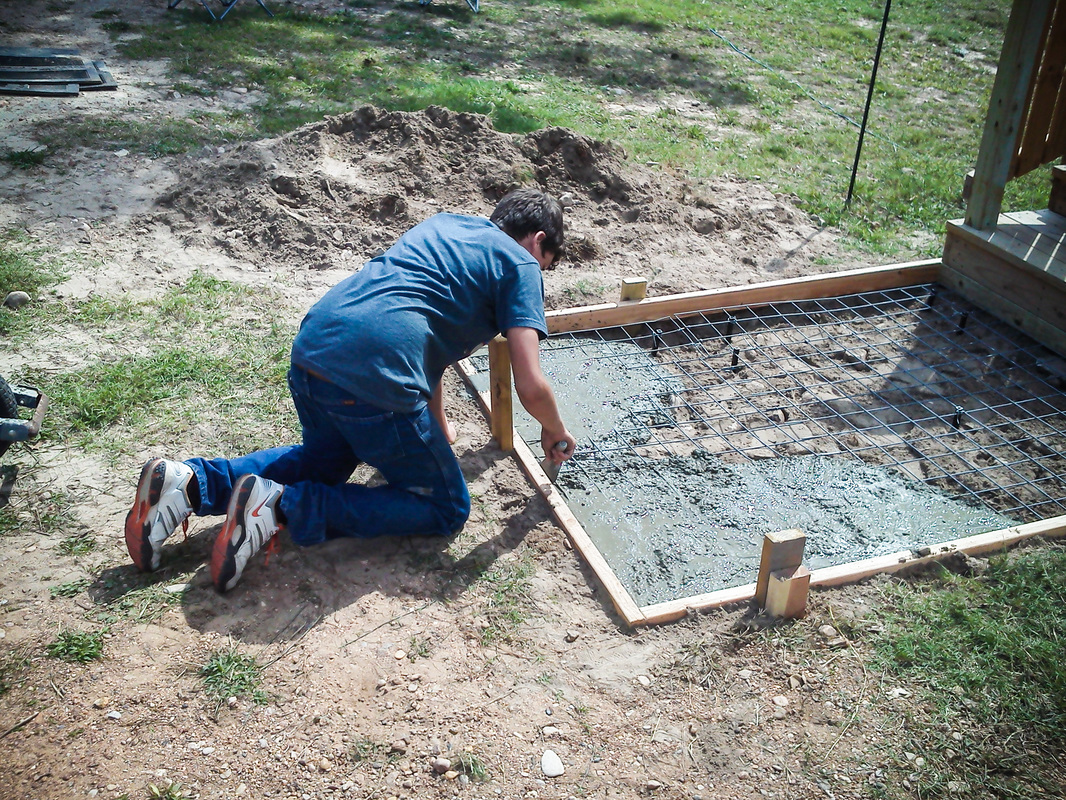 One of  the sons building his own slab for his mother.